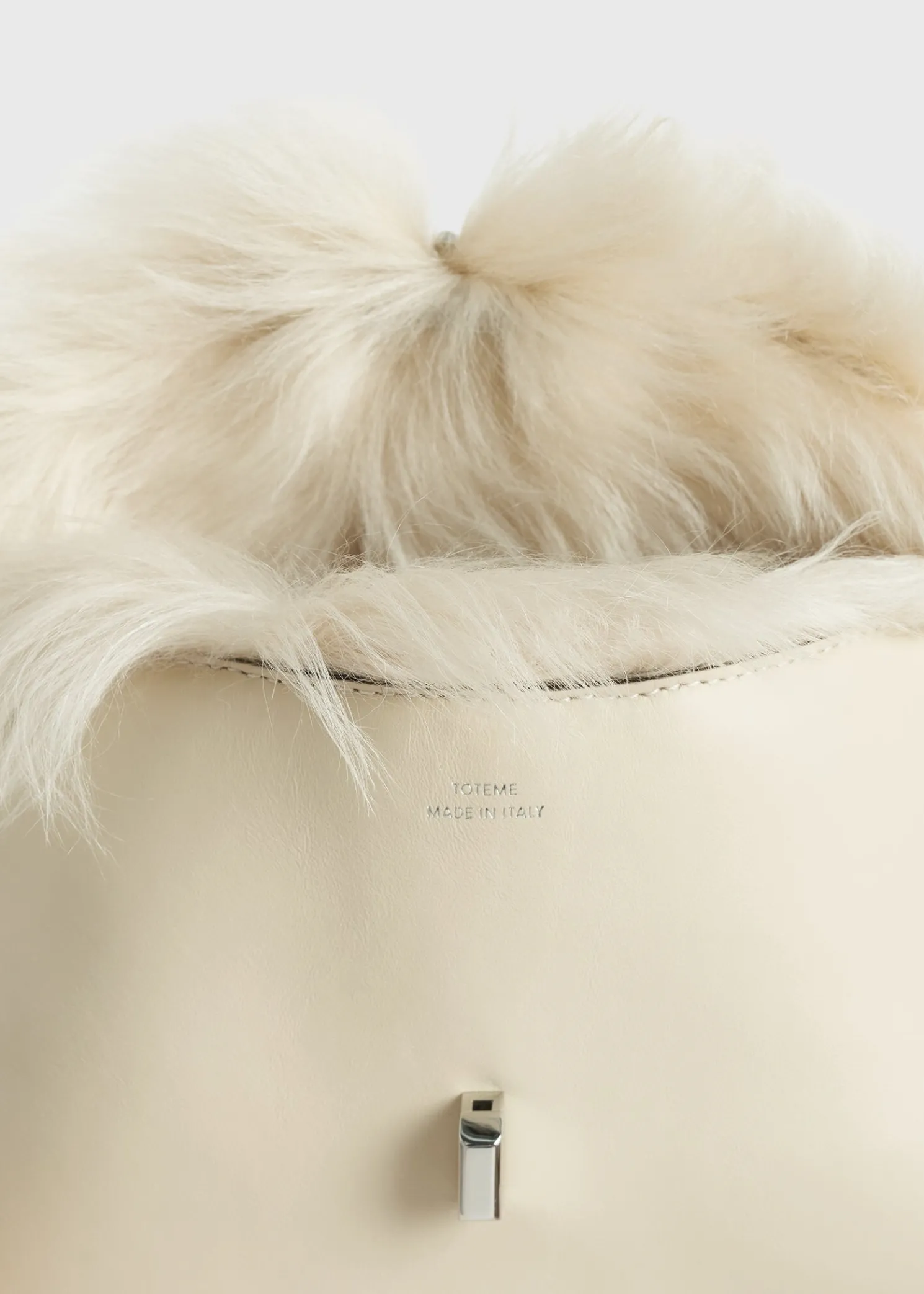 Shearling T-Lock clutch ecru