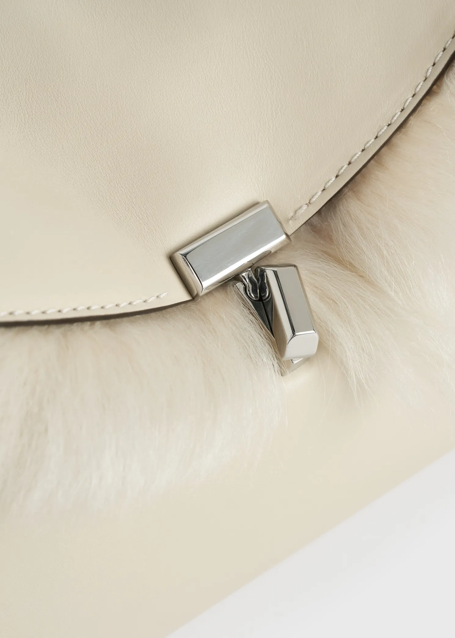 Shearling T-Lock clutch ecru